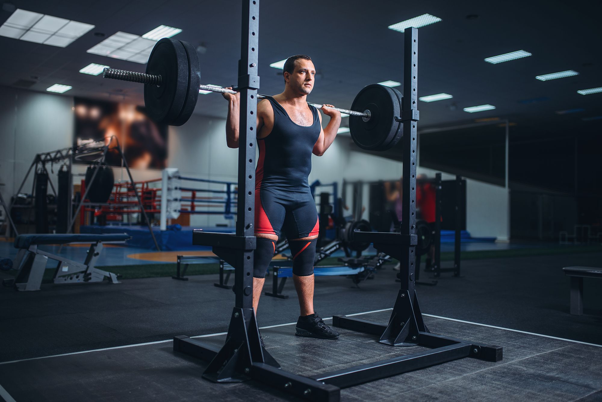 athlete prepares to do squats with barbell