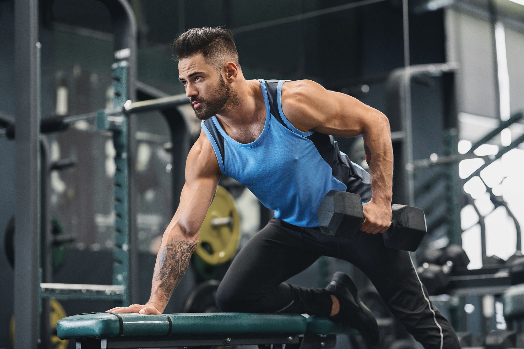 athlete working out with dumbbell at gym