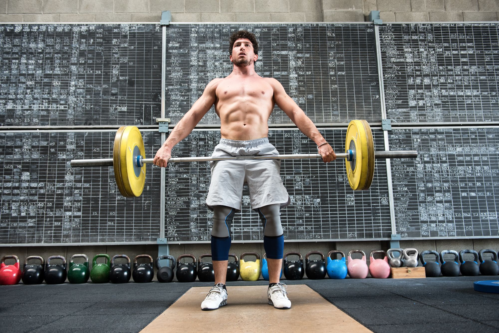 strong man lifting heavy barbell