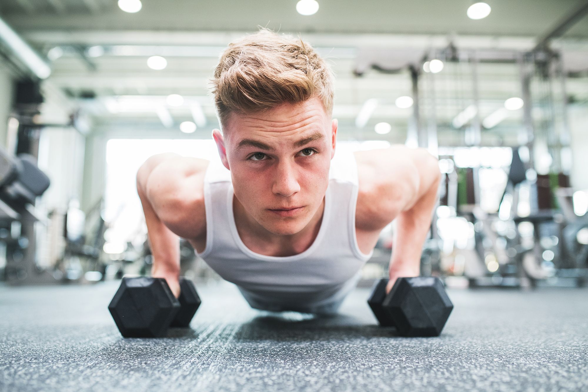 fit man in gym doing push ups